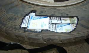 Sute de pachete de țigări ascunse în roata de rezervă a unui autoturism, descoperite la Vama Galaţi-rutier